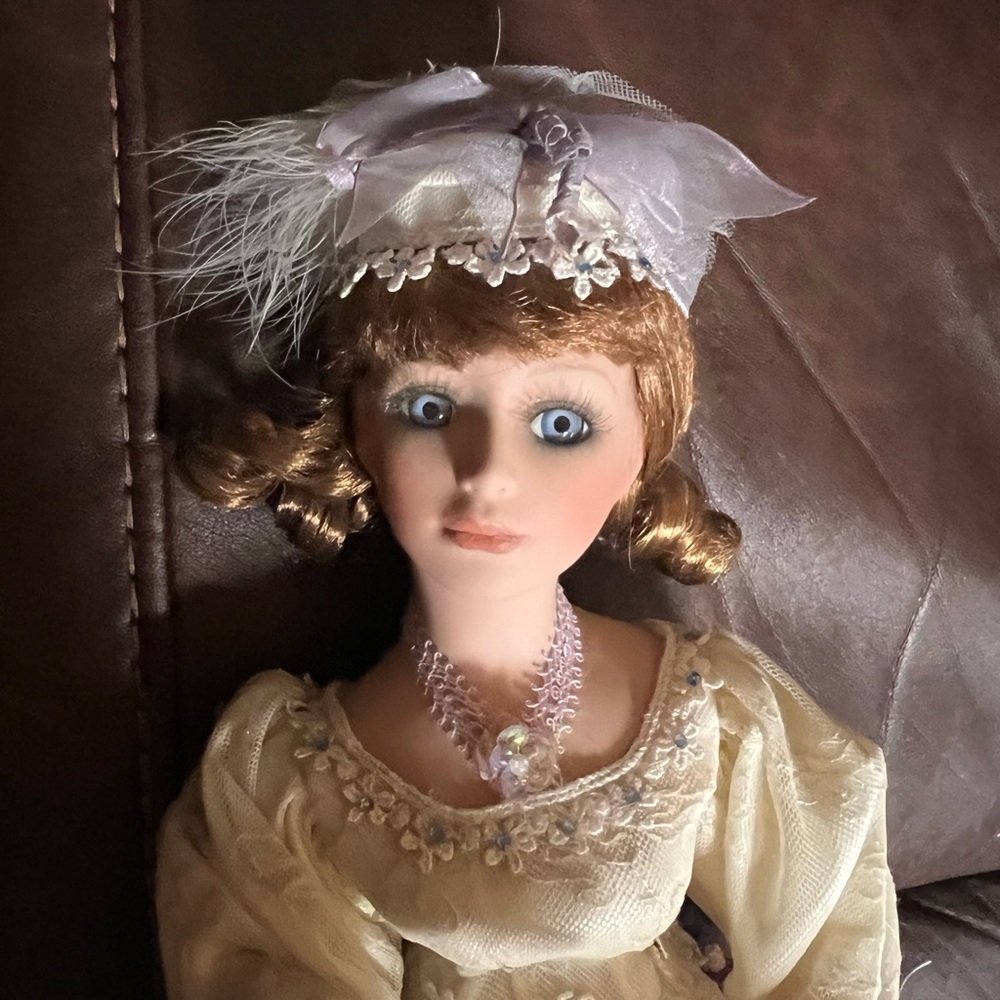 Vintage Elegant Porcelain Doll with Cream Dress and Hat